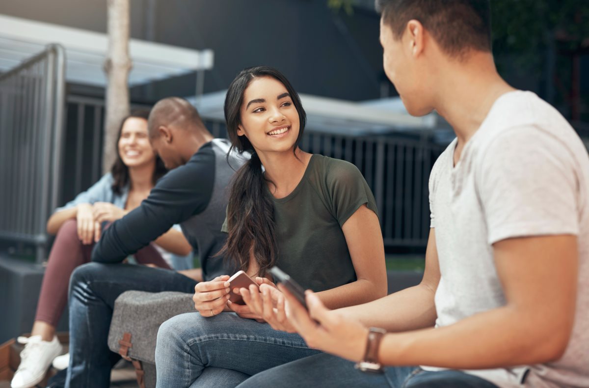 Students speaking together and smiling