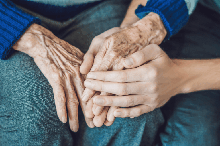 Young hands touching elderly hands