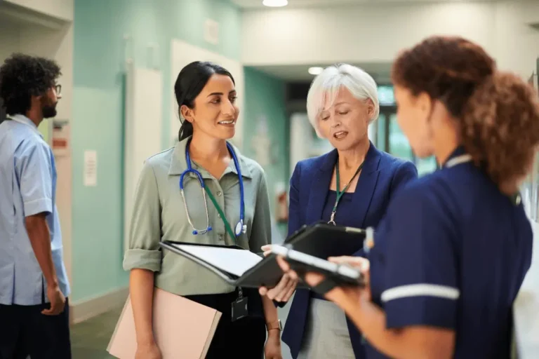 Health co-workers talking at the hospital isle