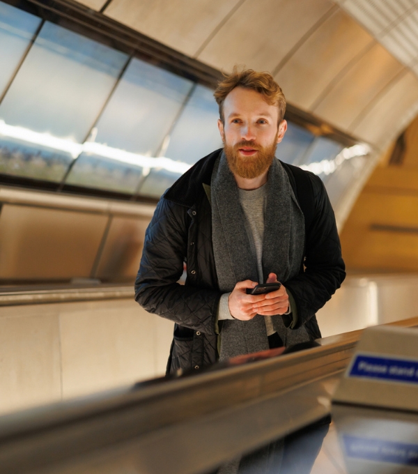 Man standing on the london underground escalator