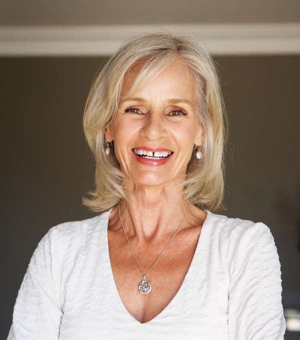 Older blonde woman smiling straight at camera