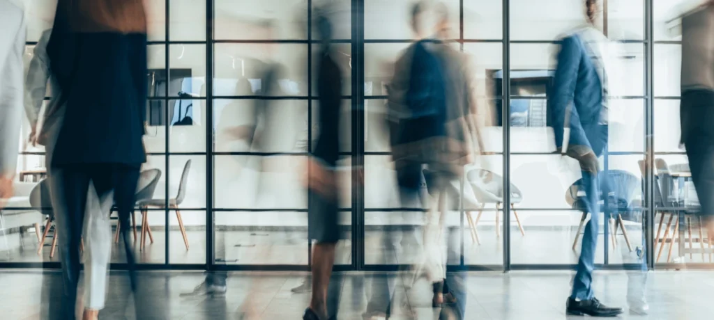 Blurred image of people going about their day in the office