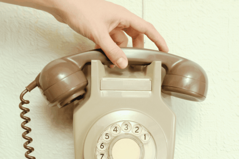 Someone answering an old style dial phone