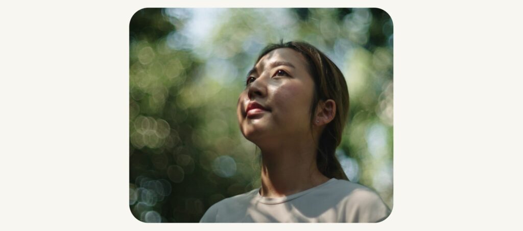 Image of young woman looking up smiling