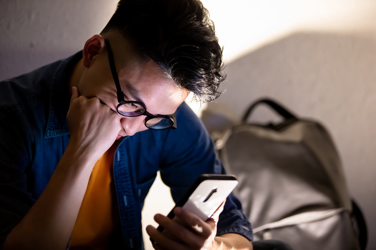 man upset while using phone