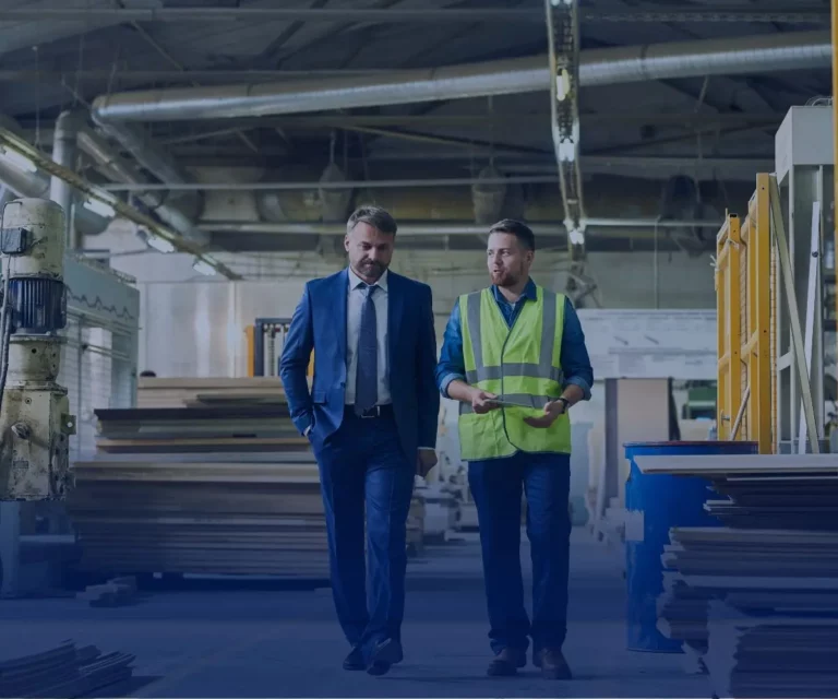 Manager and employee talking in a factory