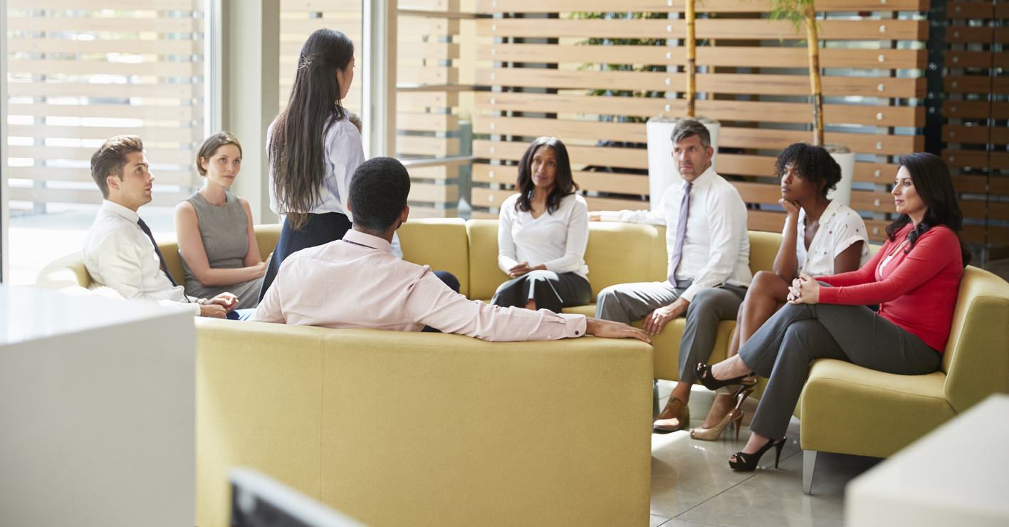 Businesswoman presenting at a team meeting in lounge area