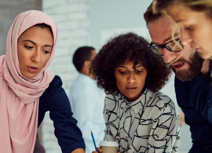 Four people actively working together.