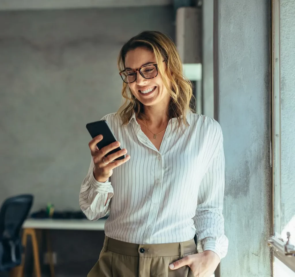 Woman looking at her phone and smiling