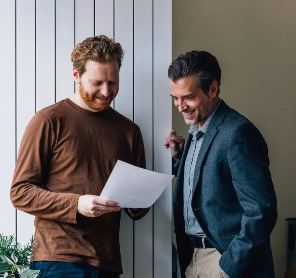 Manager talking to employee, both happy