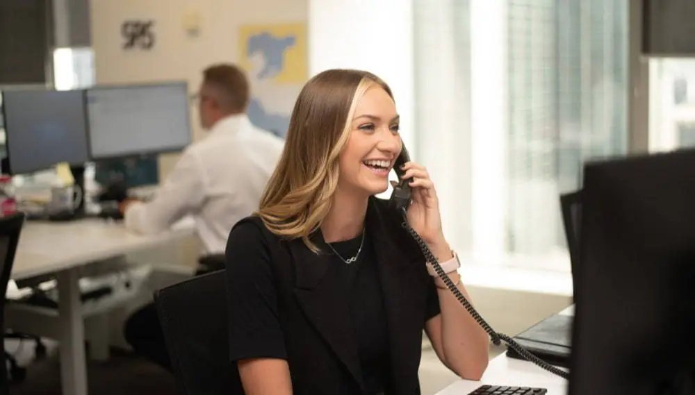 Woman smiling on the phone at work