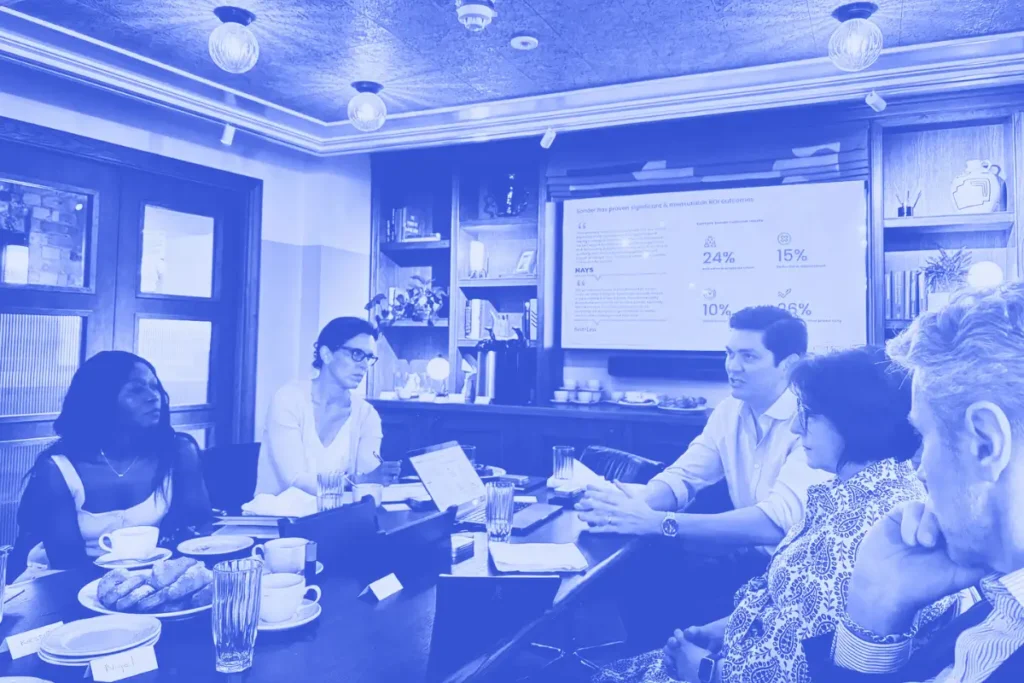 People around a table having a meeting, blue overlay