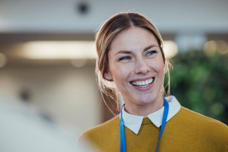 woman smiling in yellow jumper