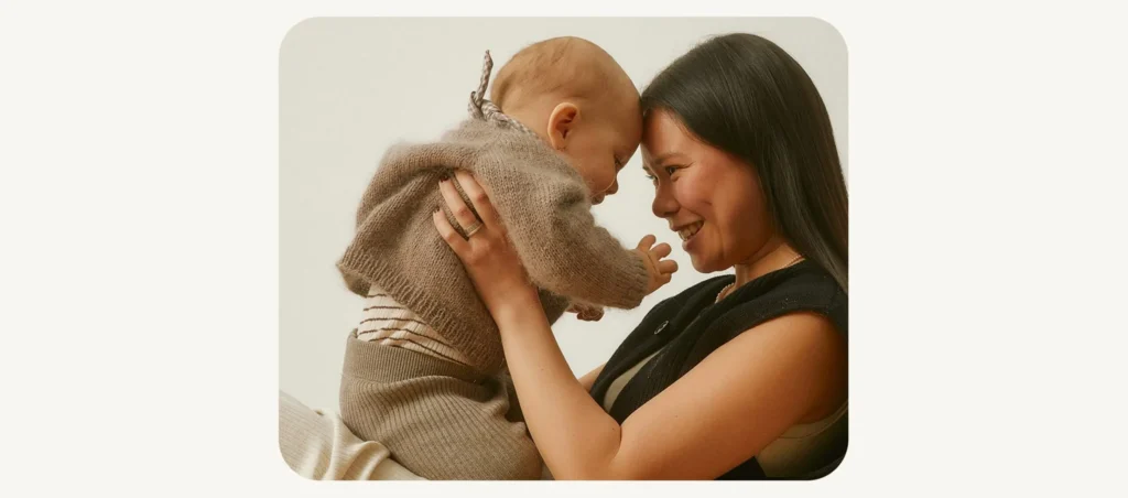 Mother holding a baby and smiling