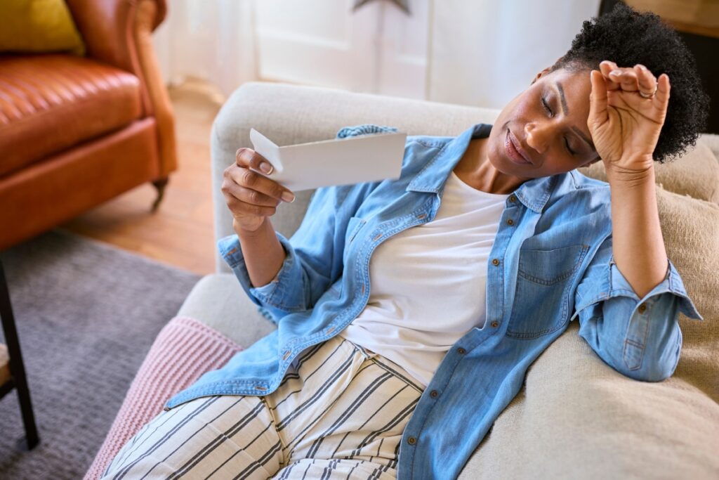 woman fanning herself, flushed