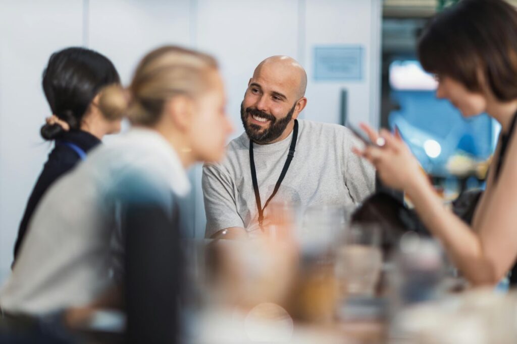 happy man at work smiling with colleagues