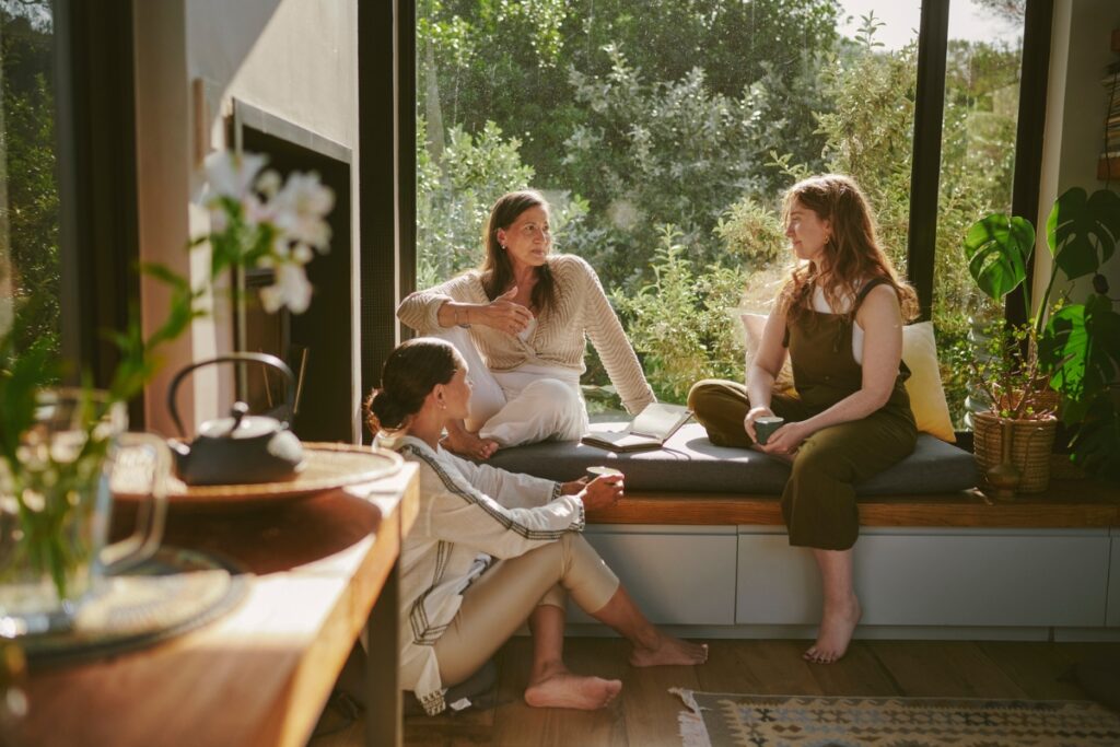 three woman sitting and talking