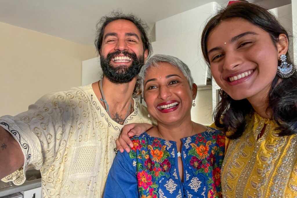 woman with two adult children smiling