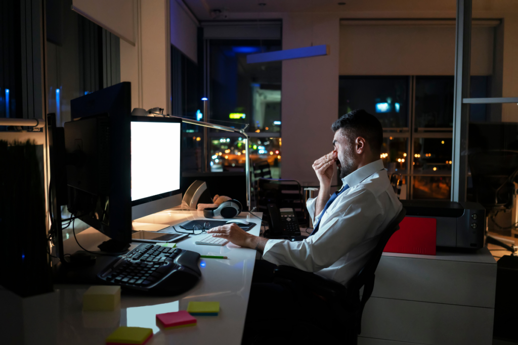 man working late at desk