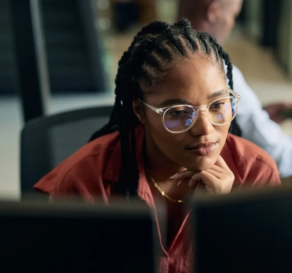 Woman looking at her desktop computer monitor at work