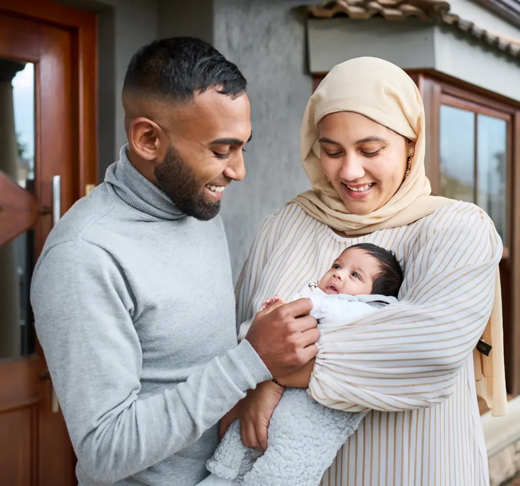 Parents smiling holding their newborn