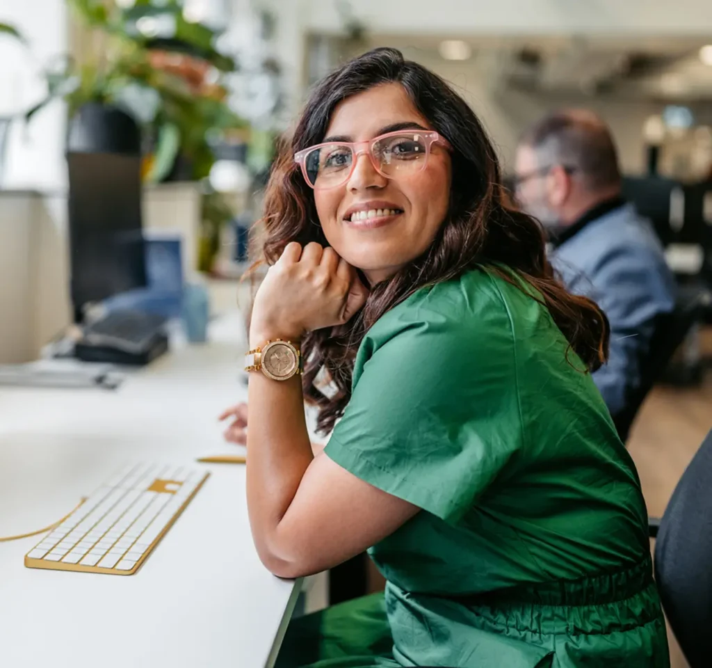 Woman at her workplace looking at the camera, smiling